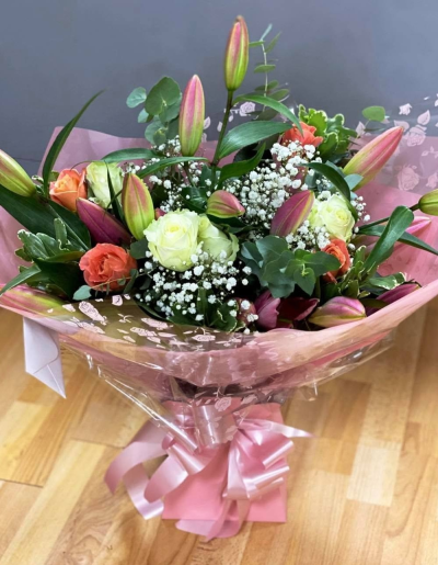 Pink Lily Delight - A cheerful bouquet in soft pink, coral and cream tones, finished with fresh greenery for a bright, elegant look.