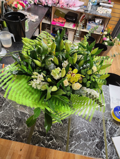 Golden Sunshine - A vibrant bouquet of sunny yellow and orange tones with rich purple accents and fresh greenery.