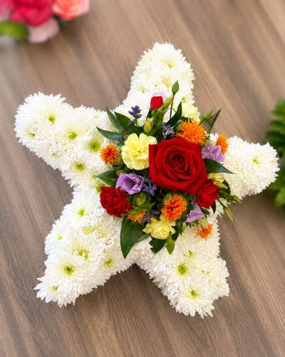 Star - A beautiful star-shaped tribute, lovingly arranged with a bright and colourful centre for a heartfelt farewell.